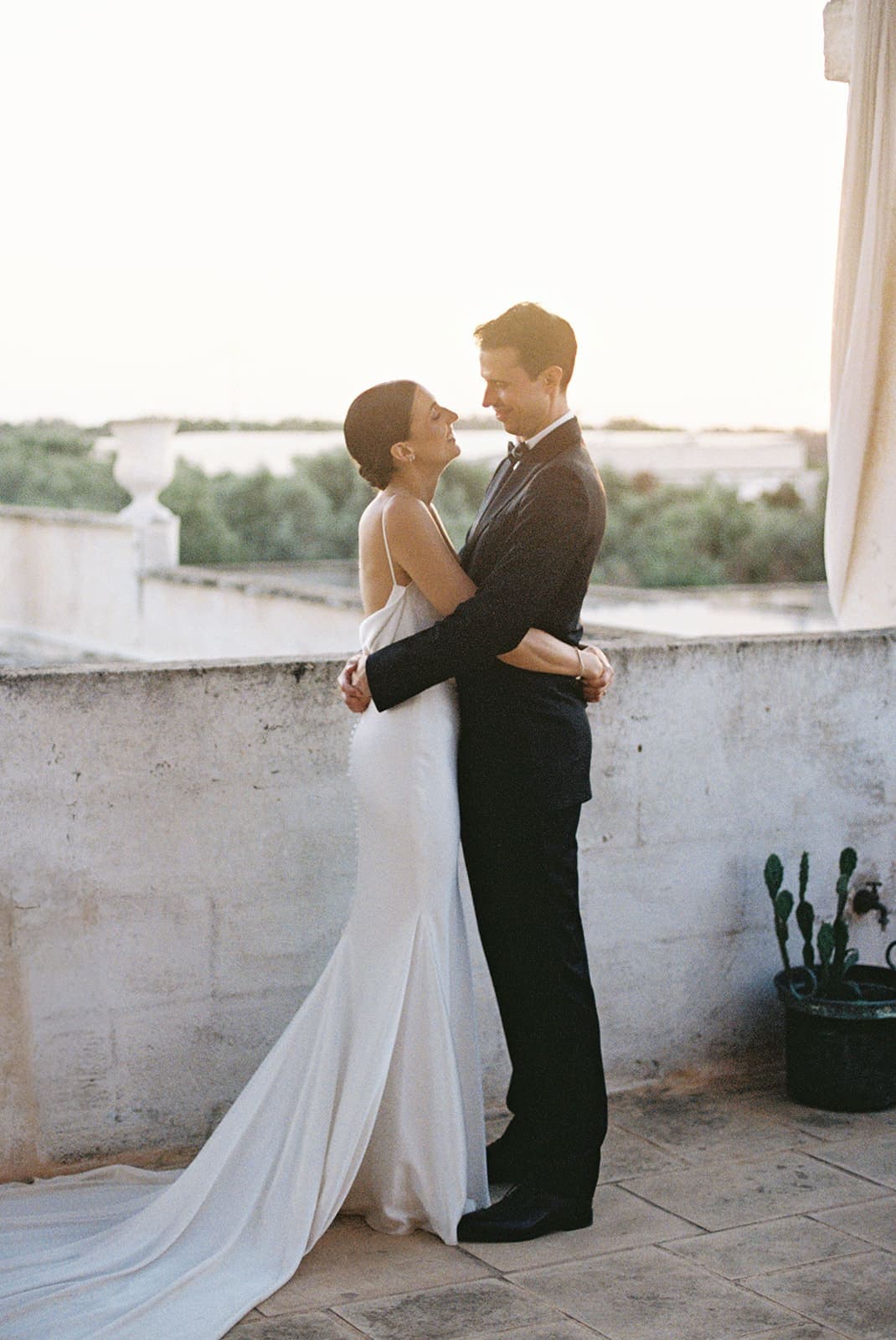 bride and groom embracing in the sunset